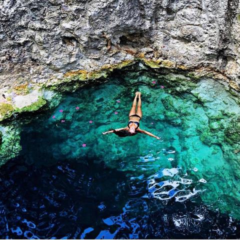 woman floating in cenote